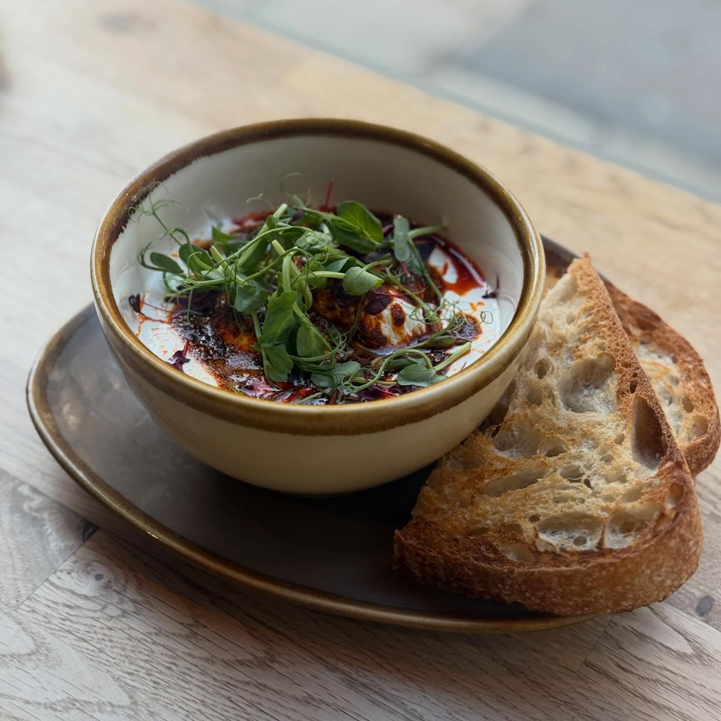 Baked eggs with chilli butter, whipped feta and sourdough