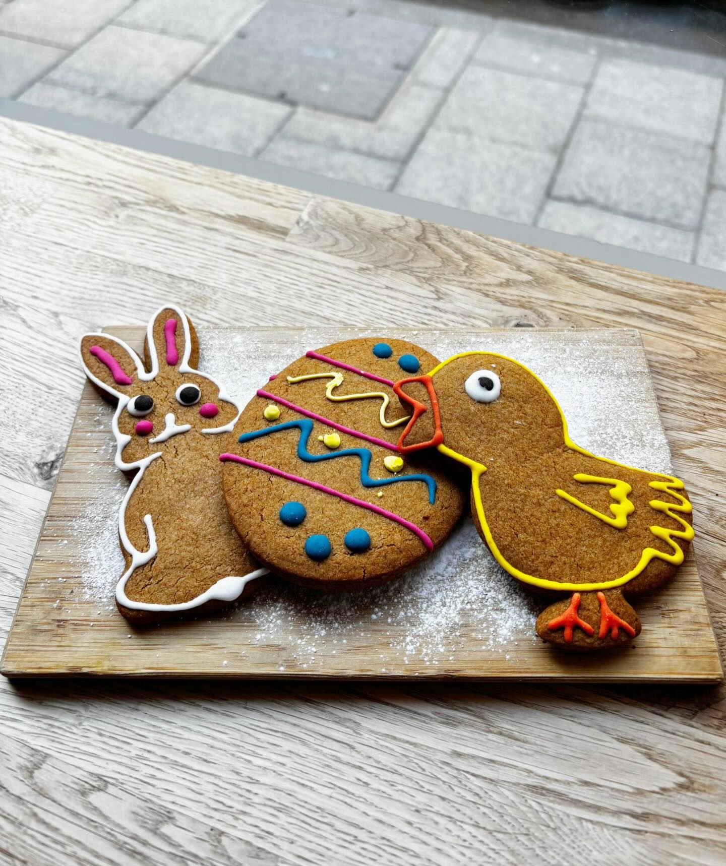 Iced Easter gingerbread biscuits on a board