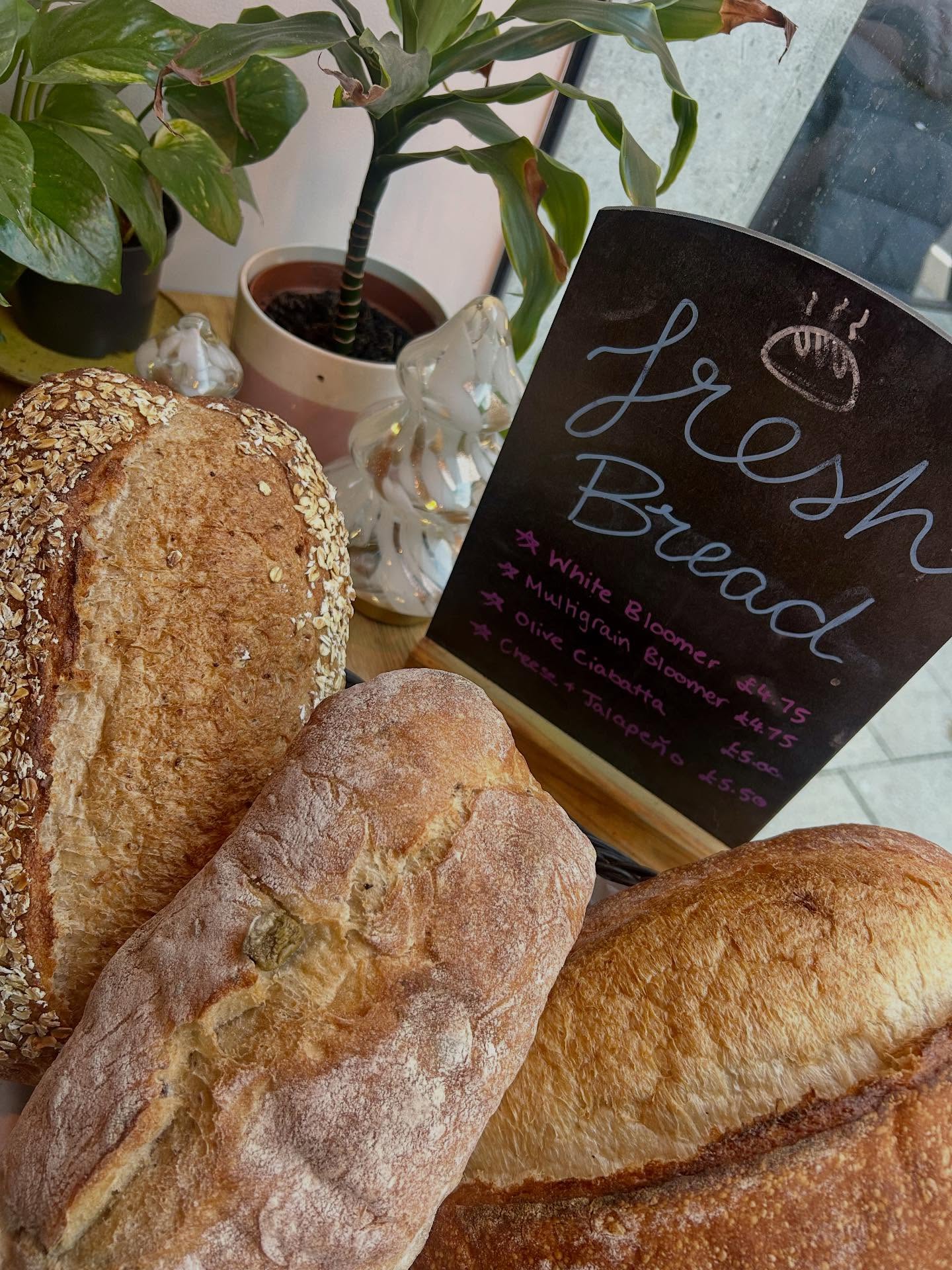 Fresh bread loaves with the daily bakery board