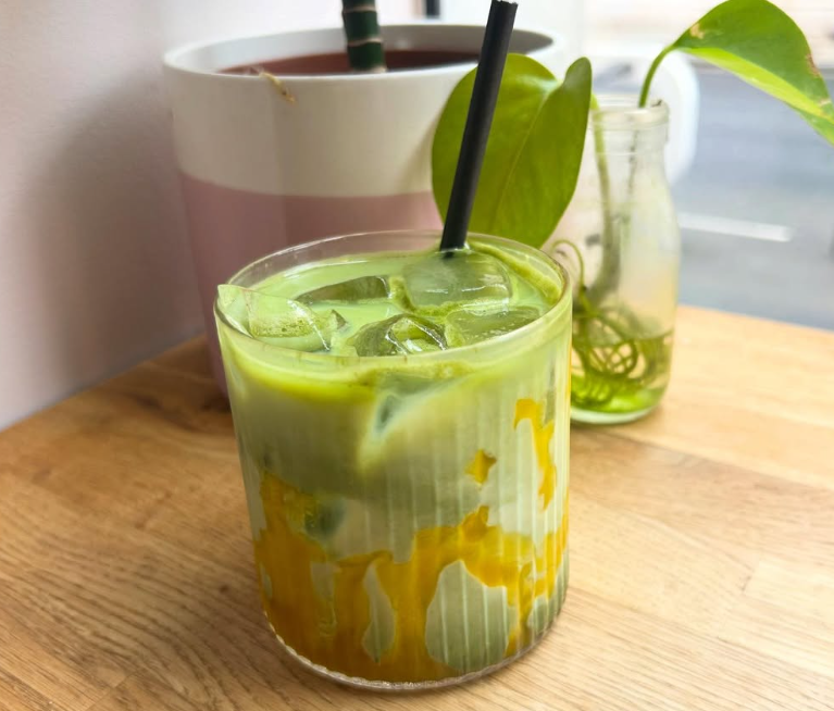 Iced mango matcha latte on a wooden table