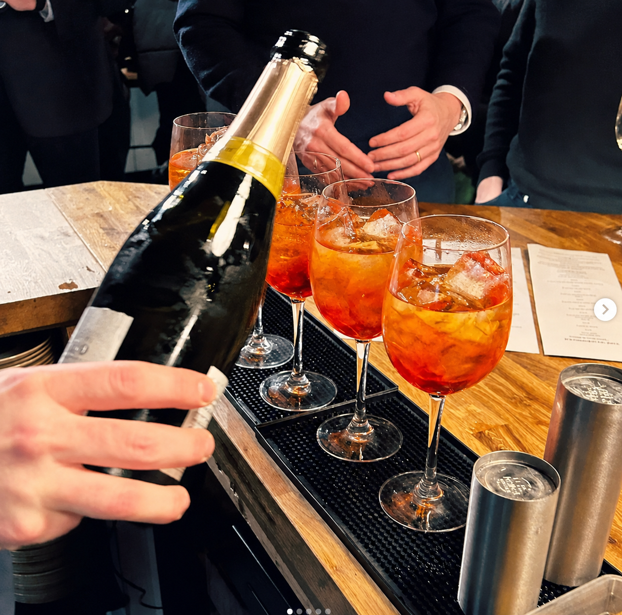 Prosecco poured into spritz cocktails at the bar