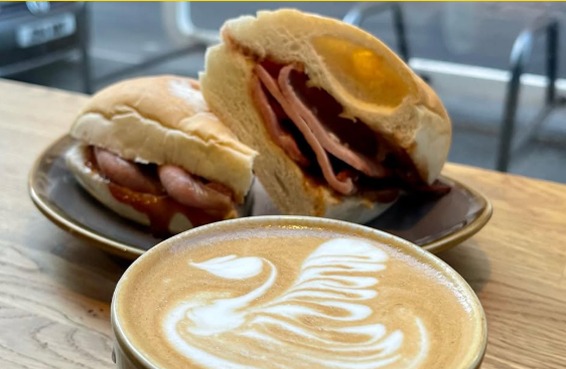 Bacon and sausage sandwiches with a latte