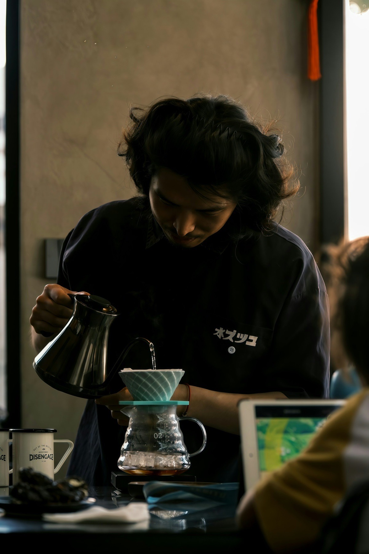 A barista making pour-over coffee